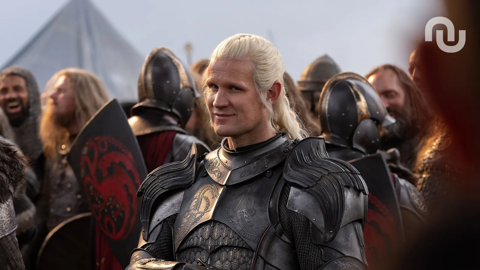 A grizzled, stern-faced warrior, Roderick Dustin, stands in armor, holding a severed head, with Northern banners in the background signaling his allegiance.
