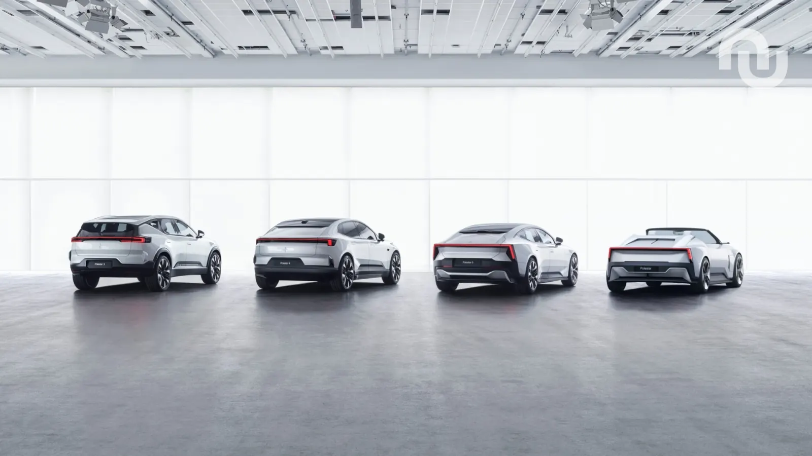 A Polestar electric car is plugged into a charging station in an urban environment.