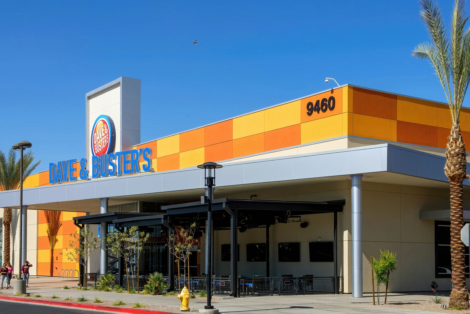 Interior view of a Dave & Buster's establishment showing dining areas and arcade game cabinets.